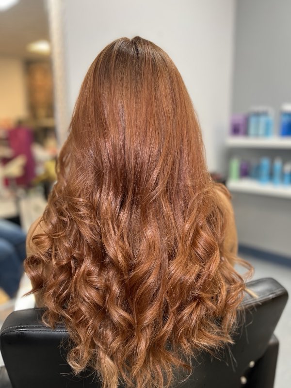Long copper-red hair with curls
